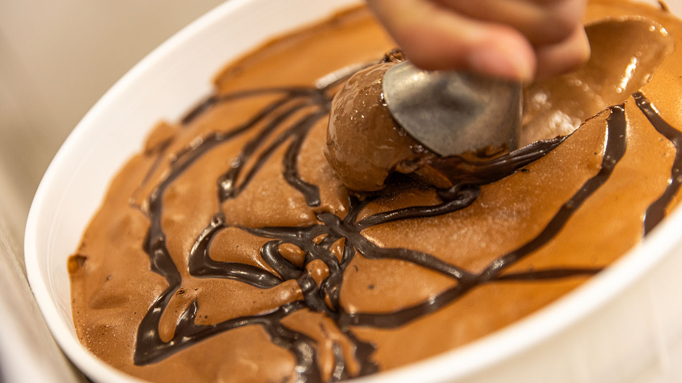Scooping fresh Over The Top chocolate ice cream.