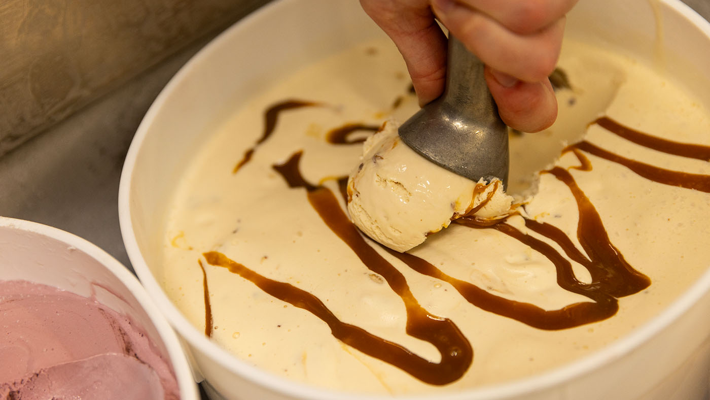 Scooping fresh Over The Top pecan ice cream.