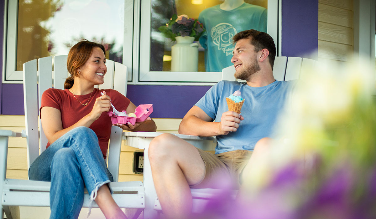 A couple eating ice cream on the Over The Top Ice Cream patio.