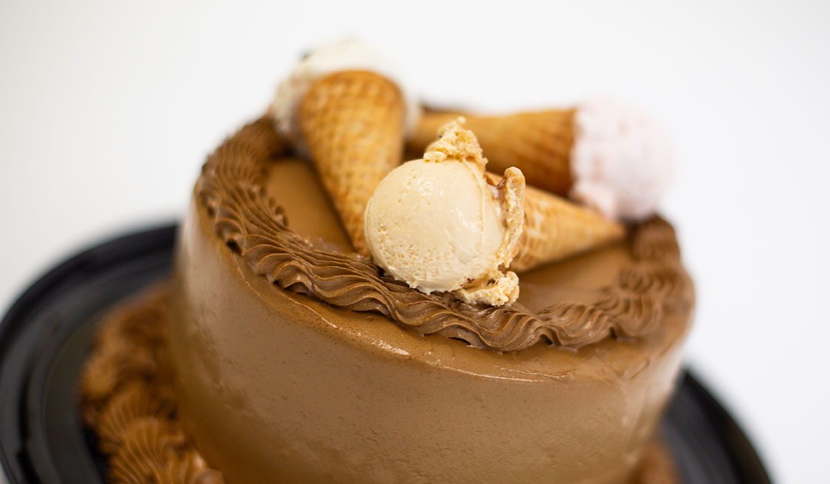 Detail of the 6-inch ice cream cake, topped with waffle cones filled with scoops of fabulicious ice cream.
