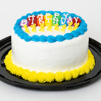 Six-inch round birthday ice cream cake, with icing in the shape of balloons spelling out "happy birthday."