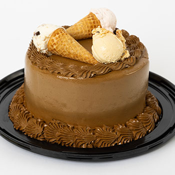 Six-inch round chocolate ice cream cake topped with three waffle cones filled with Over The Top Ice Cream.